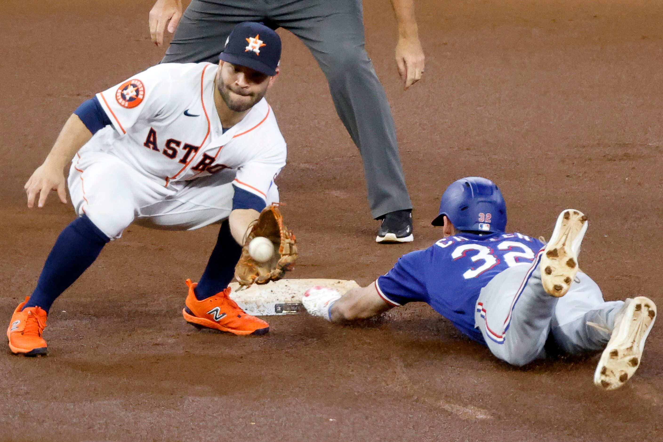 Texas Rangers left fielder Evan Carter (32) steals second base before the thrown down to...