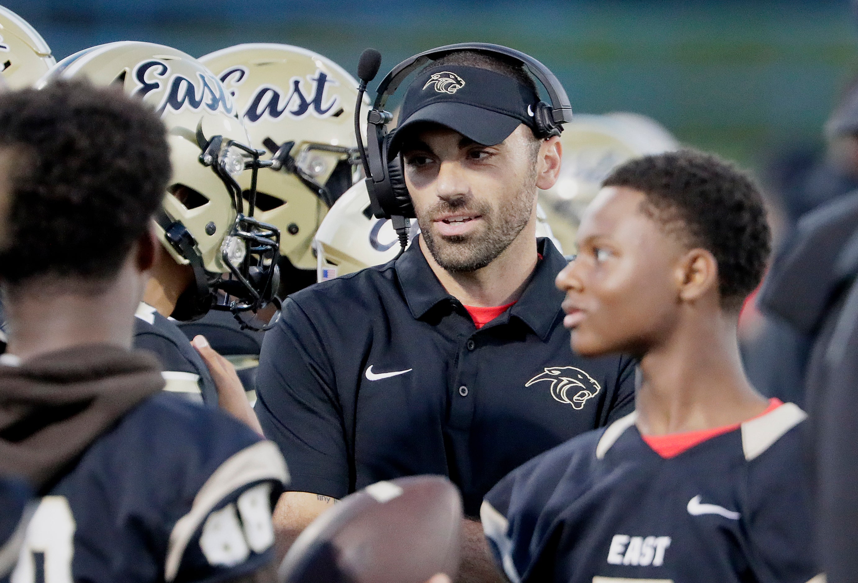 Plano East High School heac coach Tony Benedetto talks to players during the first half as...