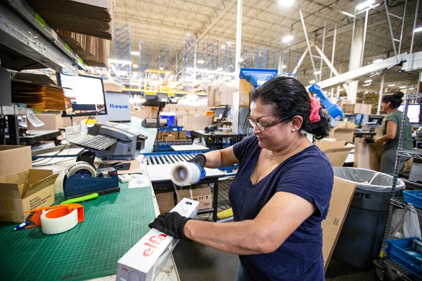 Carmen Hernandez prepares merchandise for shipping at The Container Store's distribution...