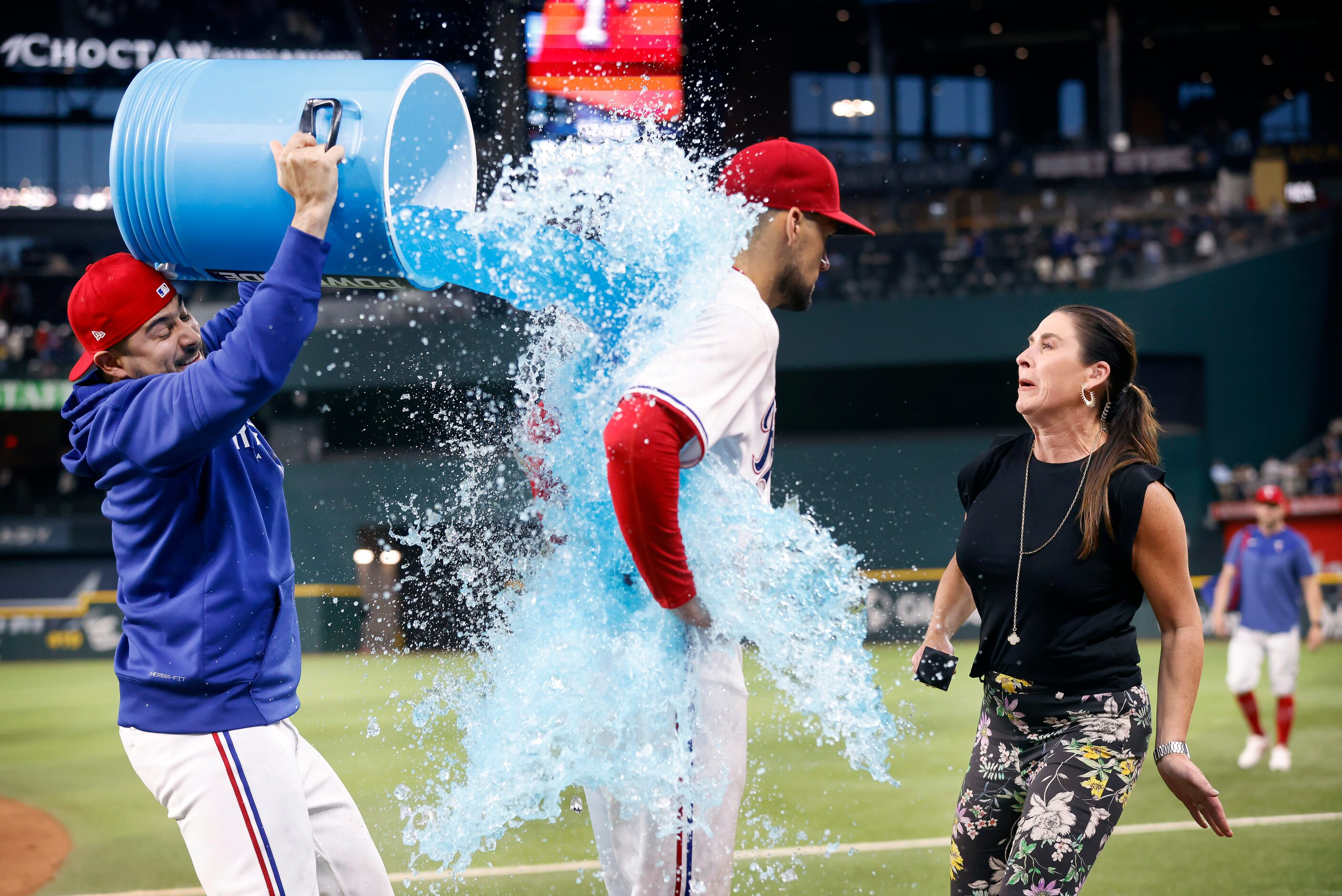 Texas Rangers starting pitcher Nathan Eovaldi (17) receives the wet end of the sports drink...