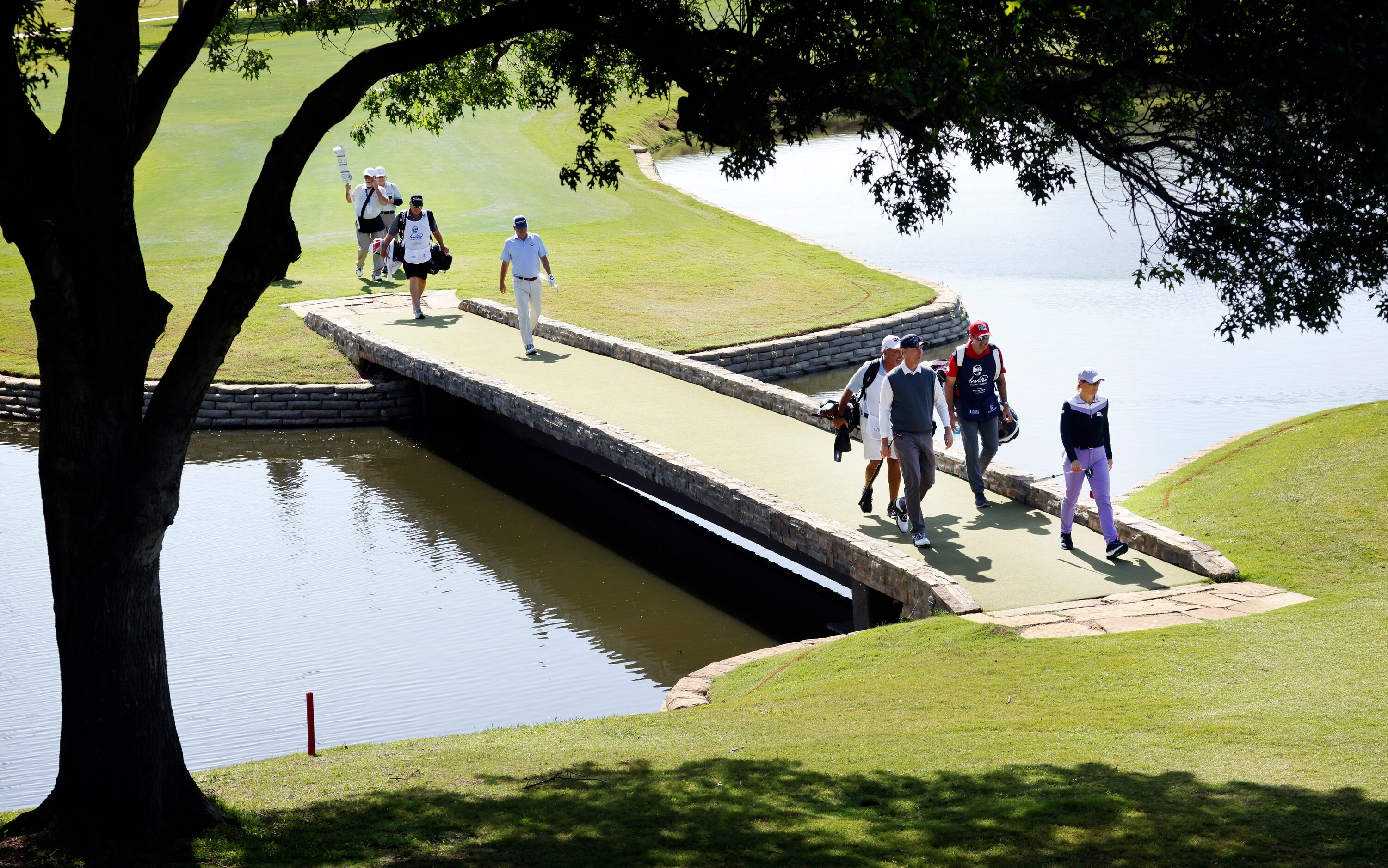 Retired LPGA golfer Annika Sorenstam (right) leads her playing partners and caddies across...