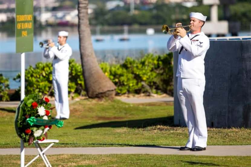 Echo taps is played during a service for the 73rd anniversary of the attack on Pearl Harbor.