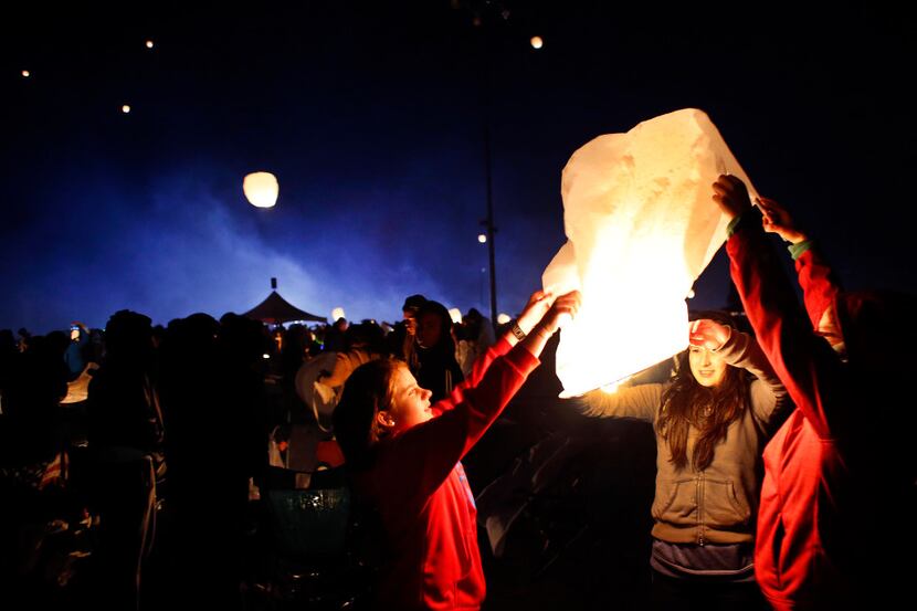 People light paper lanterns and release them into the night sky during the Lantern Festival...