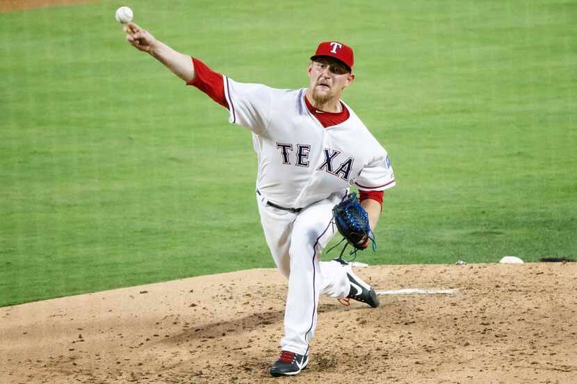 Texas Rangers starting pitcher Austin Bibens-Dirkx pitches during the third inning against...