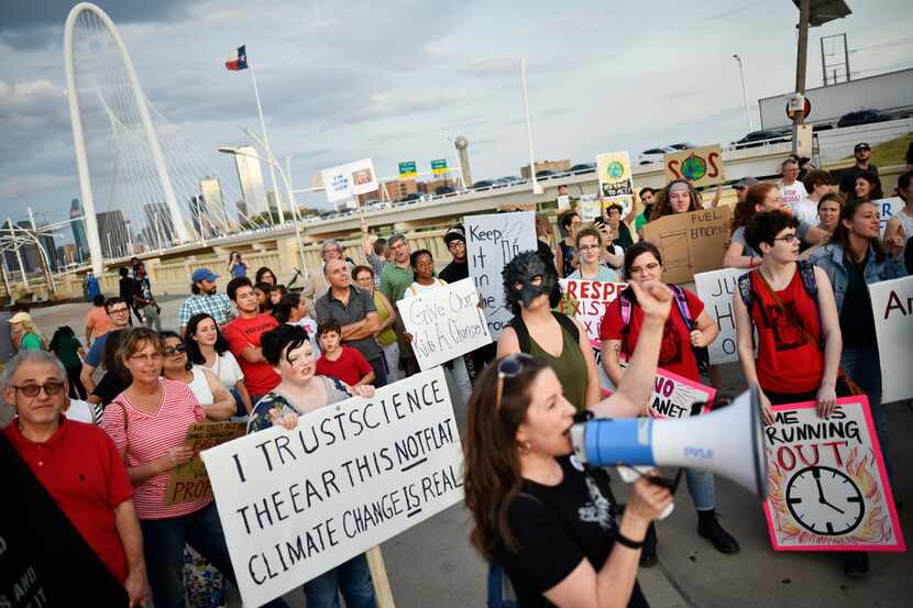 Deborah Nixon of 350 Dallas leads a series of chants during the Global Climate Strike rally...