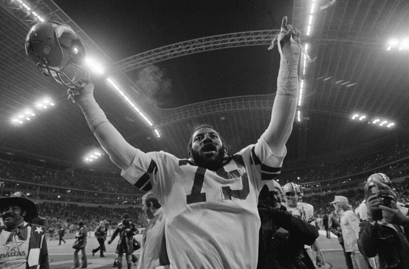 A jubilant Harvey Martin, Dallas Cowboys defensive end, raises his hands high and gives a...
