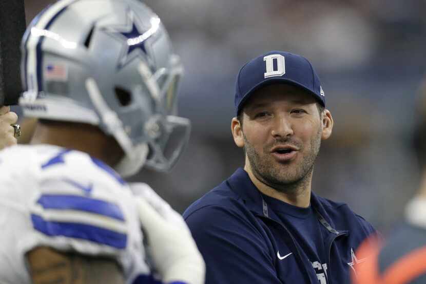 In this Sunday, Jan. 3, 2016 photo, Dallas Cowboys' Tony Romo talks with teammates on the...