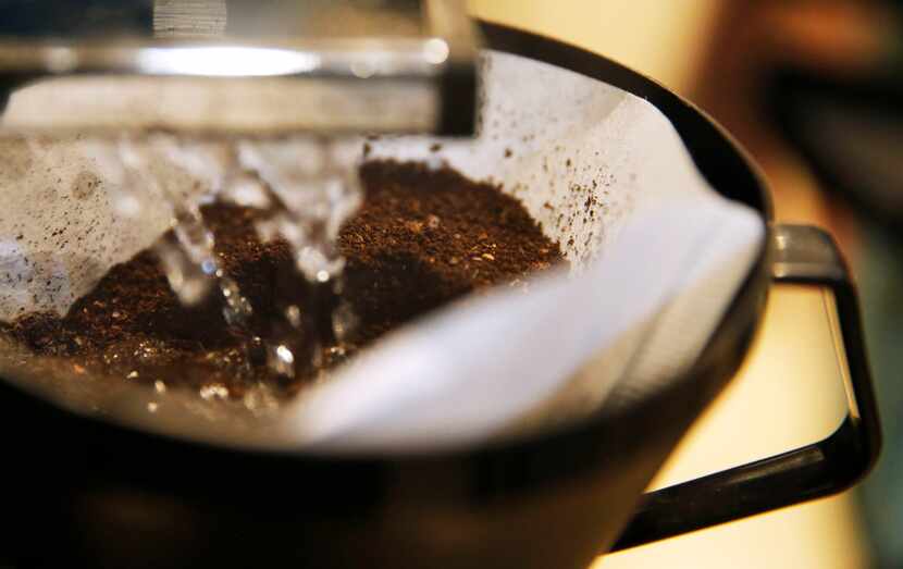 Keith Marton brews a batch of coffee from his home roasted coffee beans at his home in Dallas.