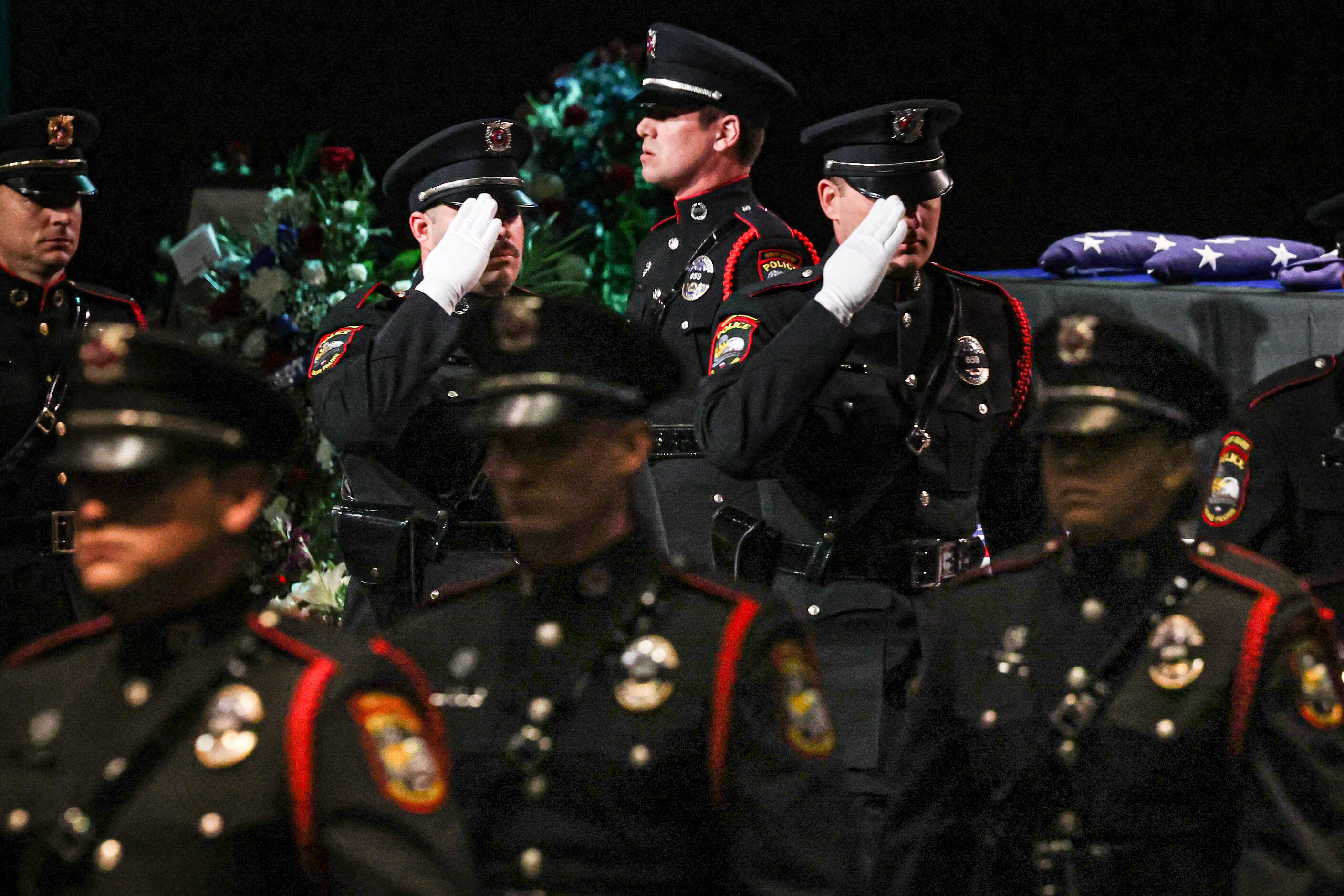 Grand Prairie Police Department Honor Guard members walk past the casket of Grand Prairie...