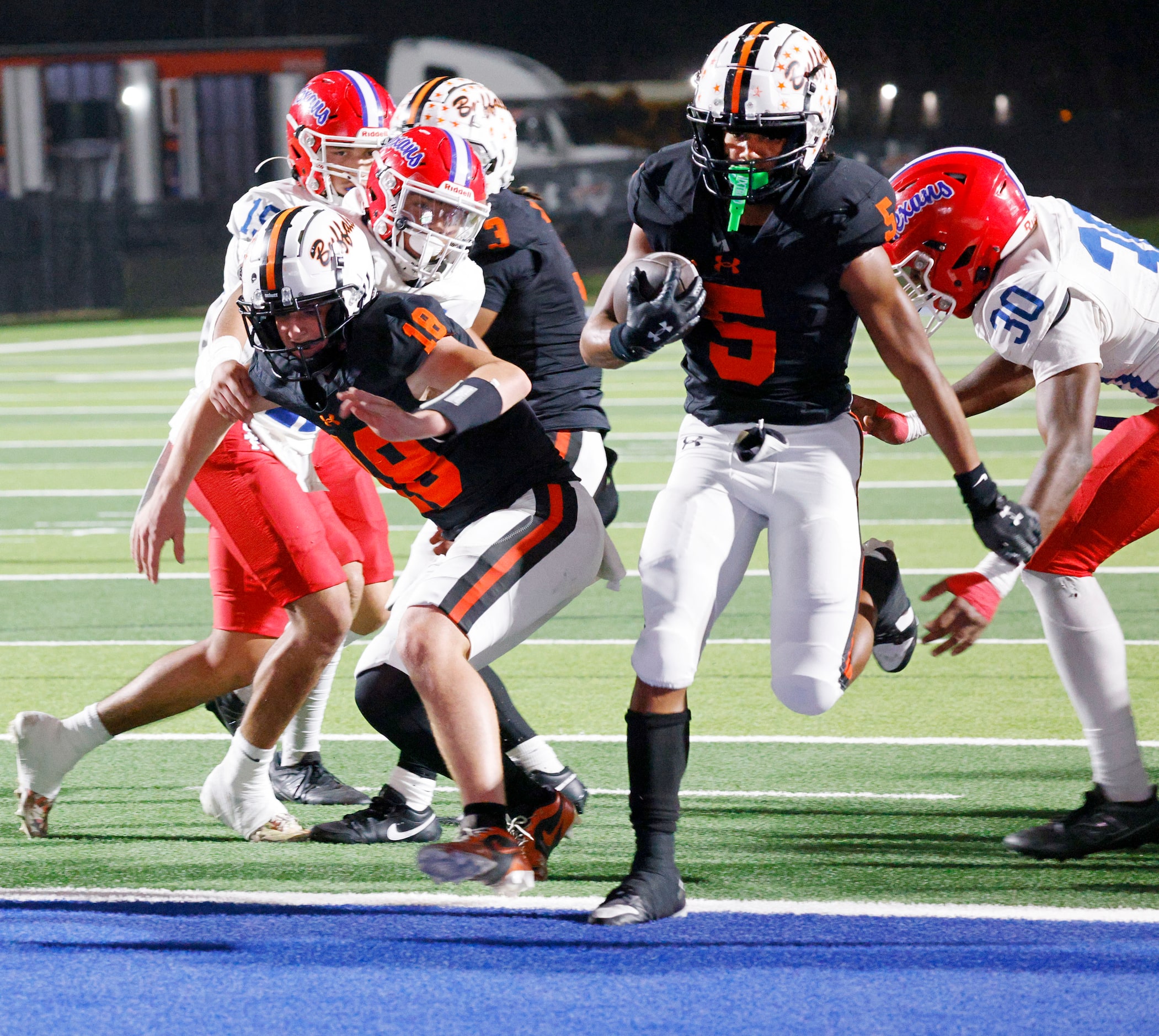 Haltom's Vudrico Roberson (5) scores a touchdown over Sam Houston defense players in the...