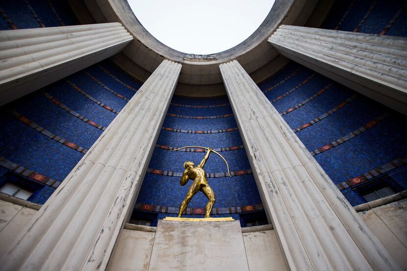 A gold leaf Tejas Warrior statue is paired with original blue tiles outside the historic...