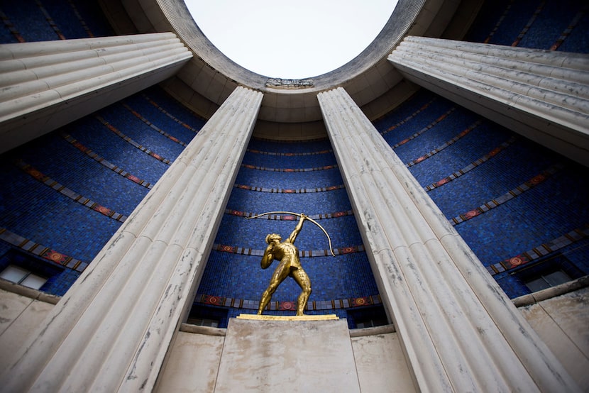 A gold leaf Tejas Warrior statue is paired with original blue tiles outside the historic...