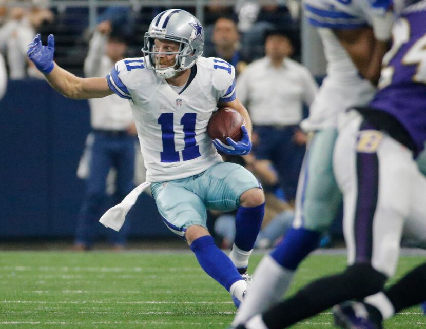 Dallas Cowboys wide receiver Cole Beasley (11) looks to gain more yardage after catching a...