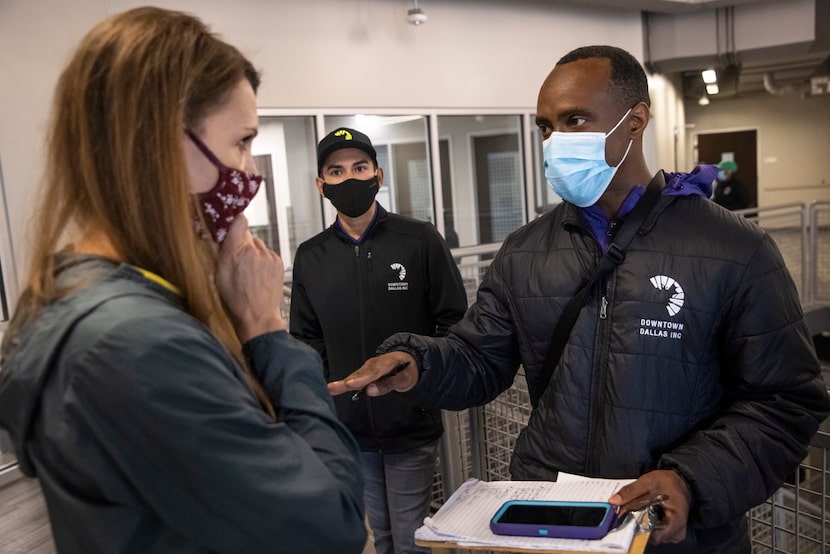 Downtown Dallas, Inc.'s Albert Sanchez (center) listens as Anthony Murphy talks with...