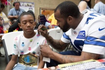  Dallas Cowboy running back Darren McFadden gives 9-year-old Jaelon Williams a new paint job...