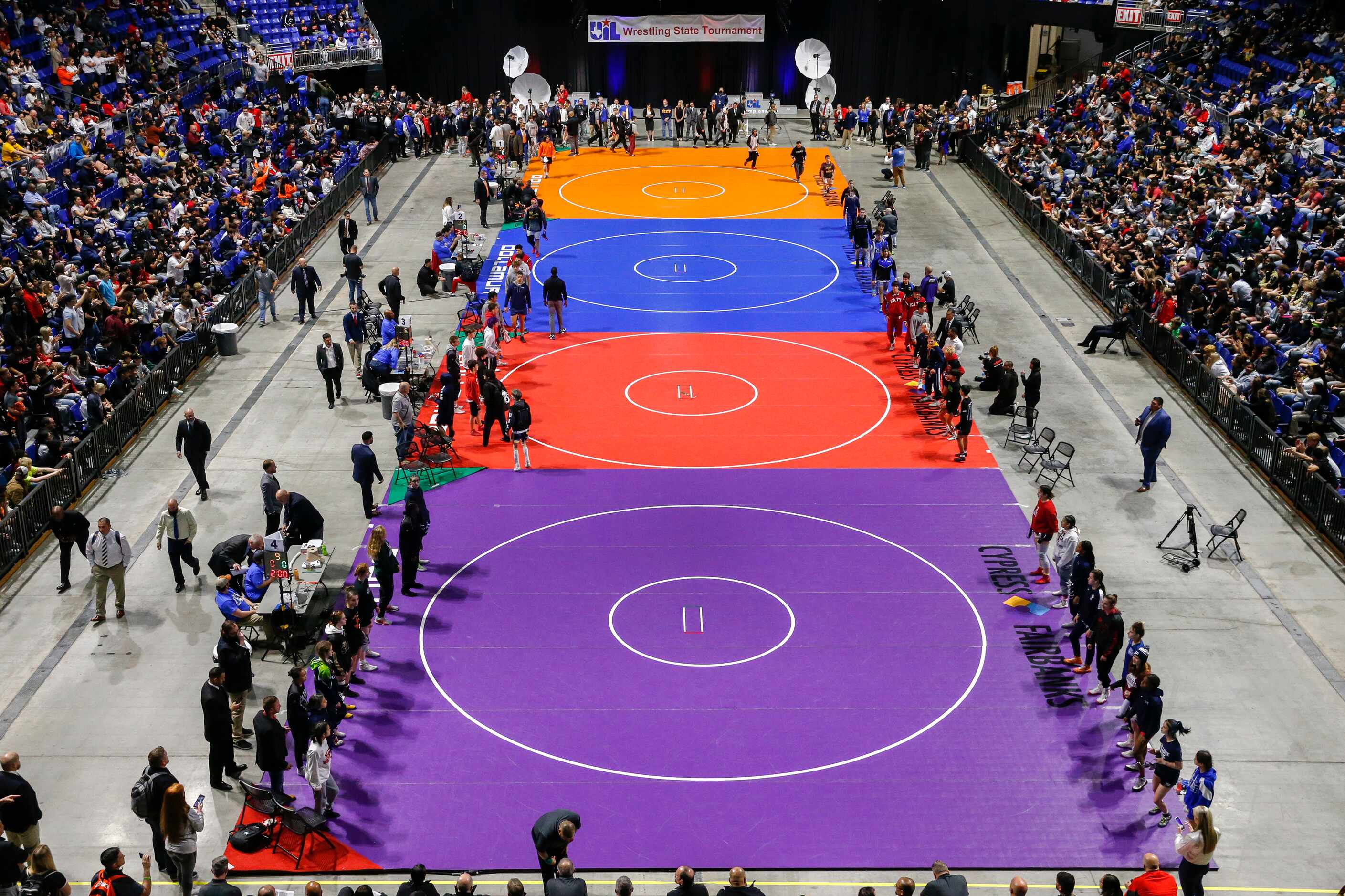 Wrestlers enter the arena floor during the parade of champions at the UIL State Wrestling...