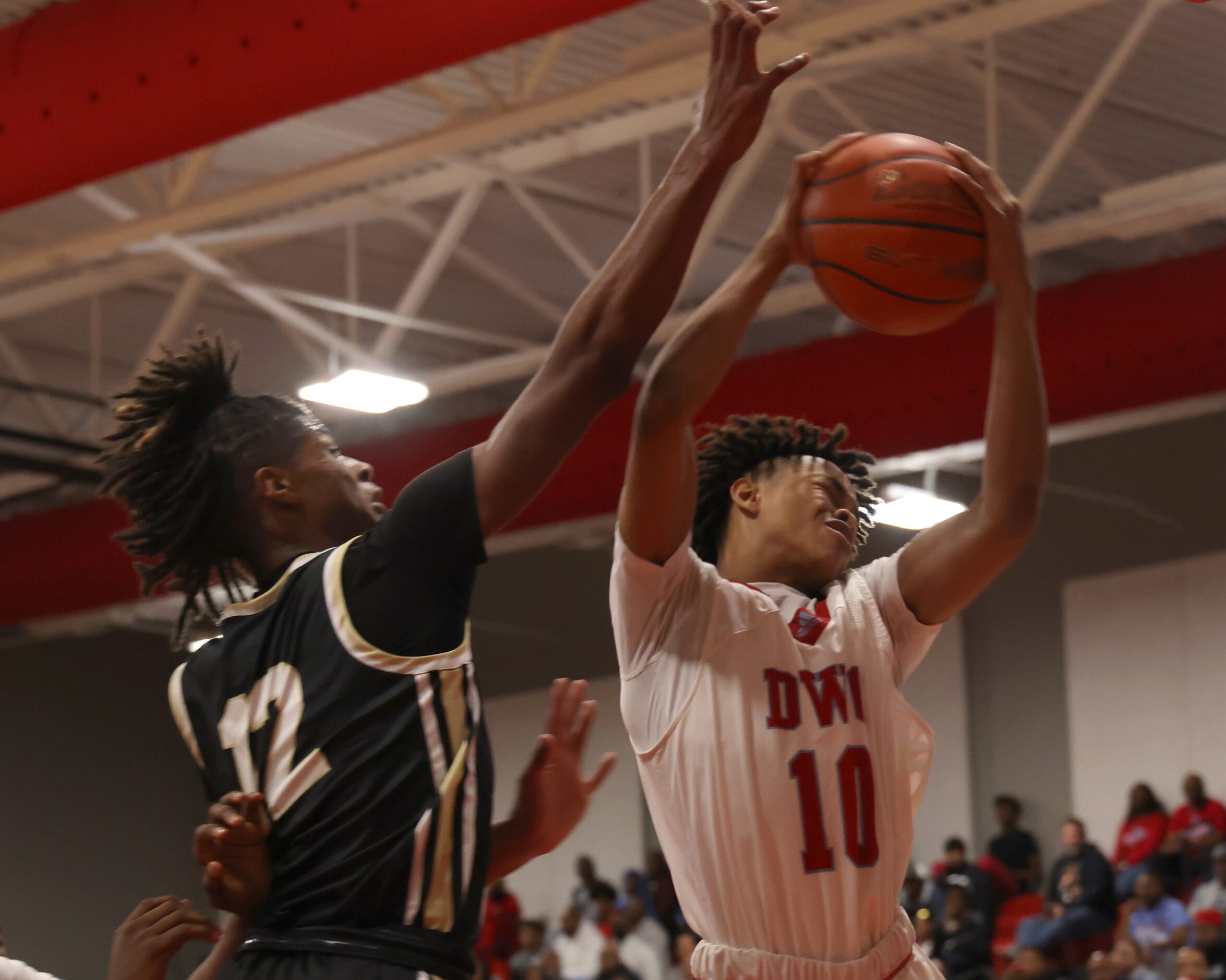 Dallas Carter guard Jammarian Stevenson (10), winces as he comes down with a rebound as he...