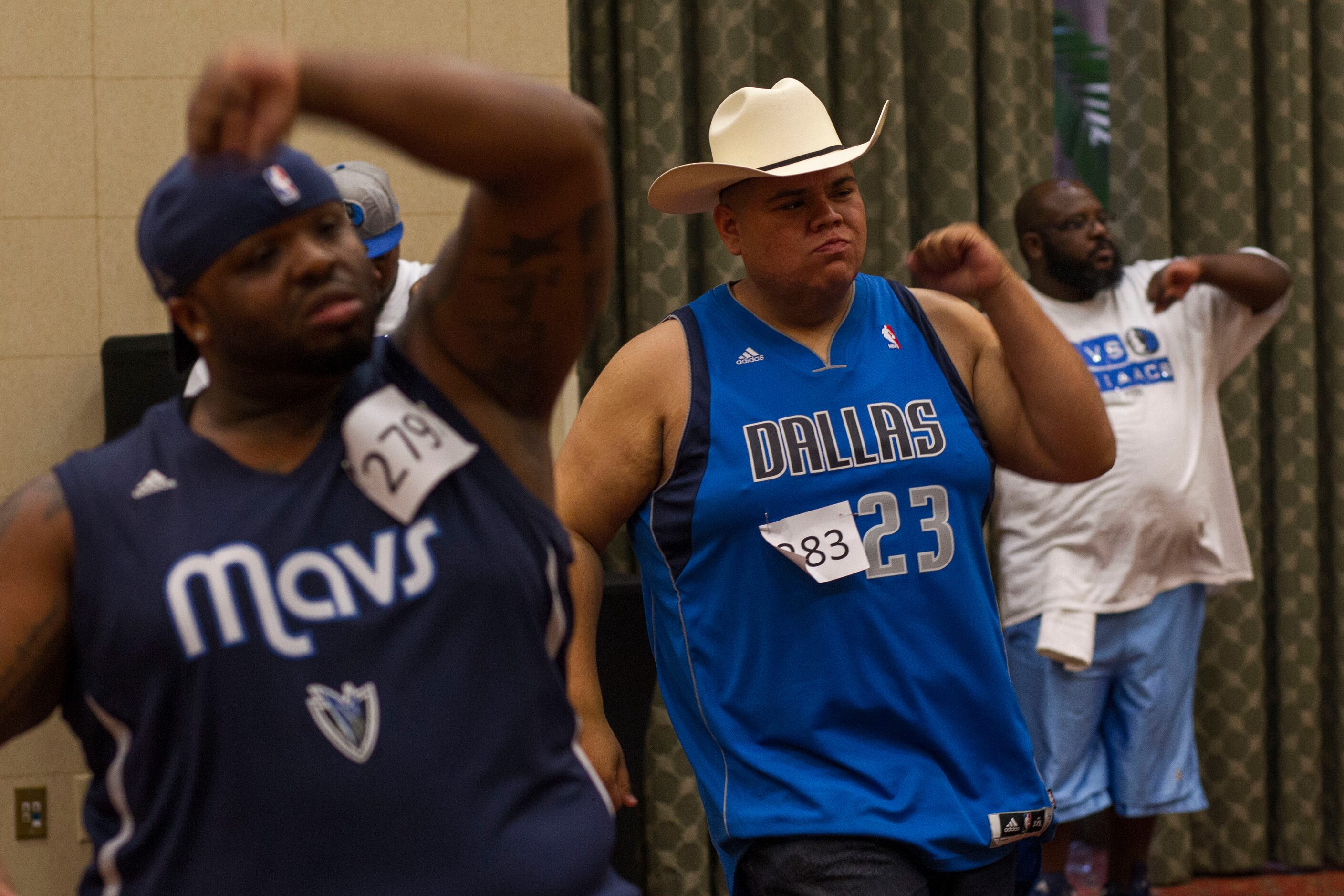 Martin Arredondo, center, of Dallas, practices dance moves for The Mavs ManiAACs tryouts,...