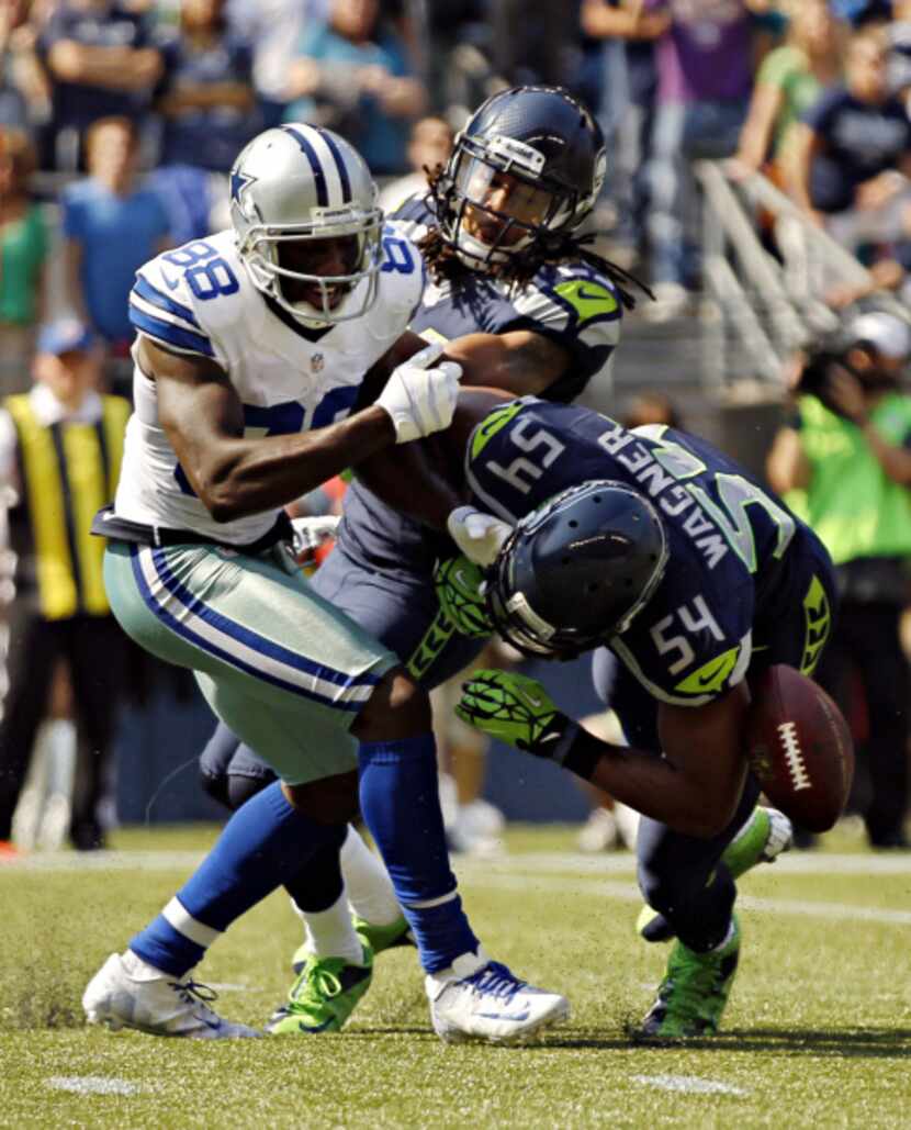 Seattle Seahawks middle linebacker Bobby Wagner (54) and free safety Earl Thomas (29) force...