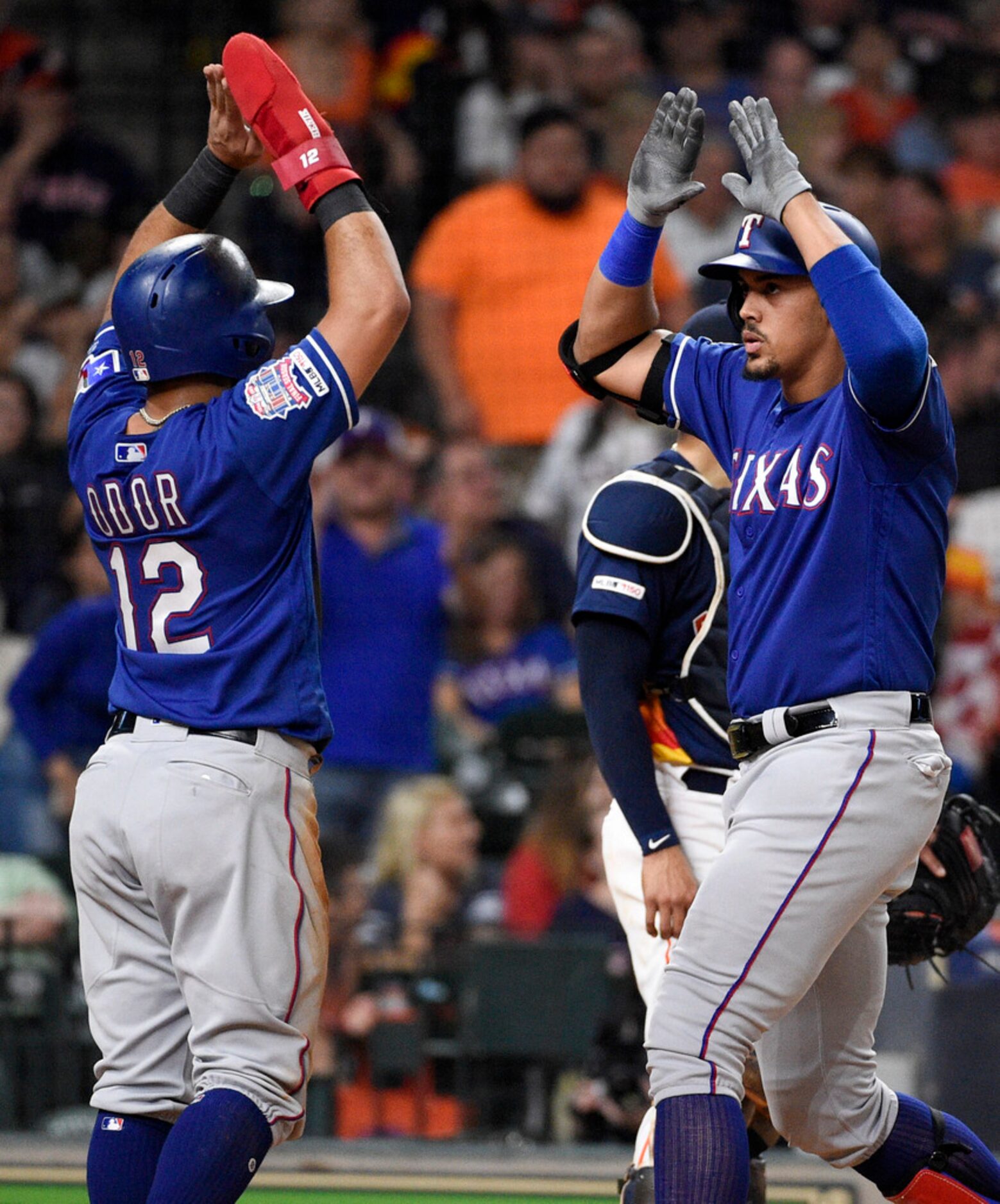 Texas Rangers' Ronald Guzman, right, celebrates his three-run home run off Houston Astros...