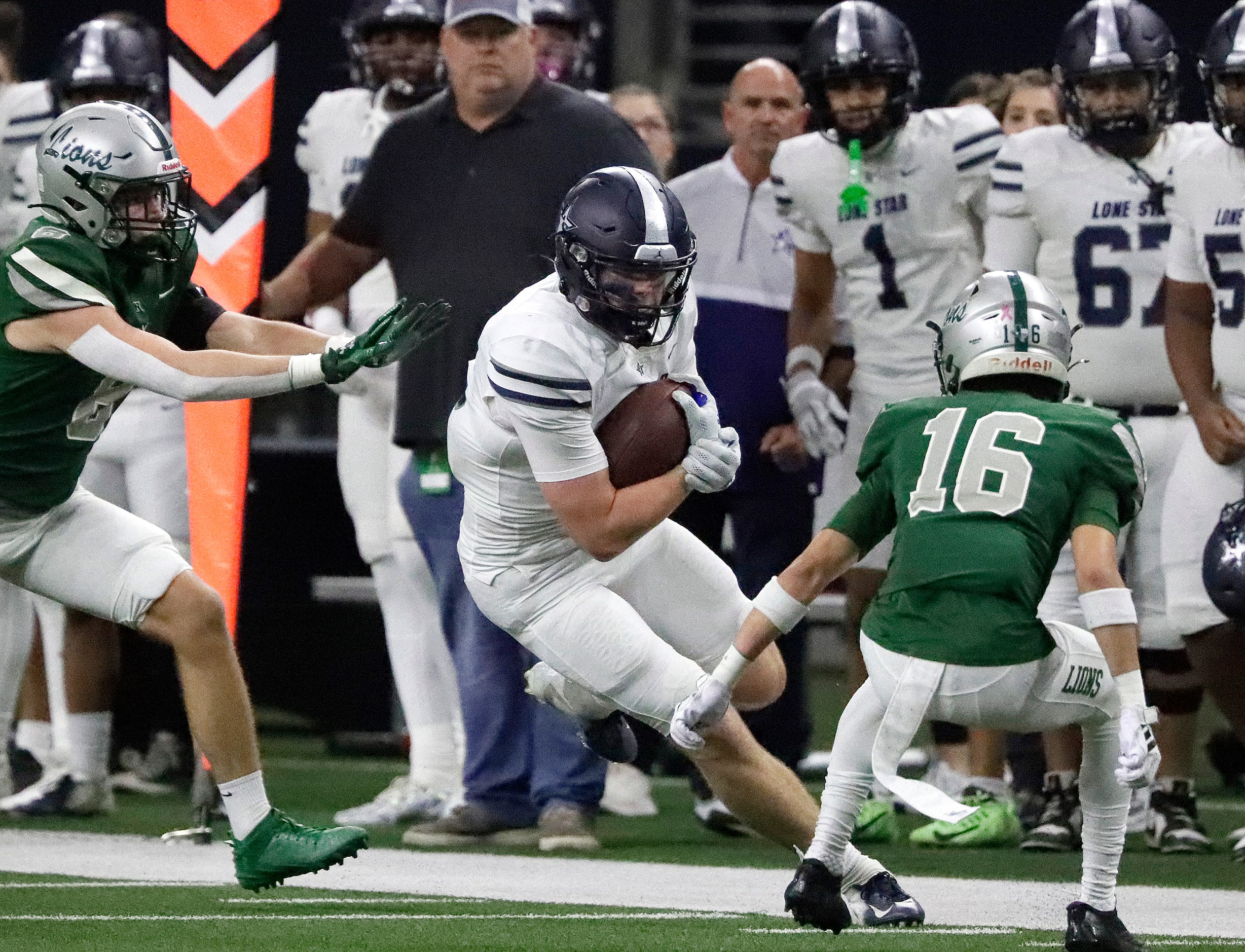 Lone Star High School receiver Ryder Mix (12) prepares for contact during the first half as...