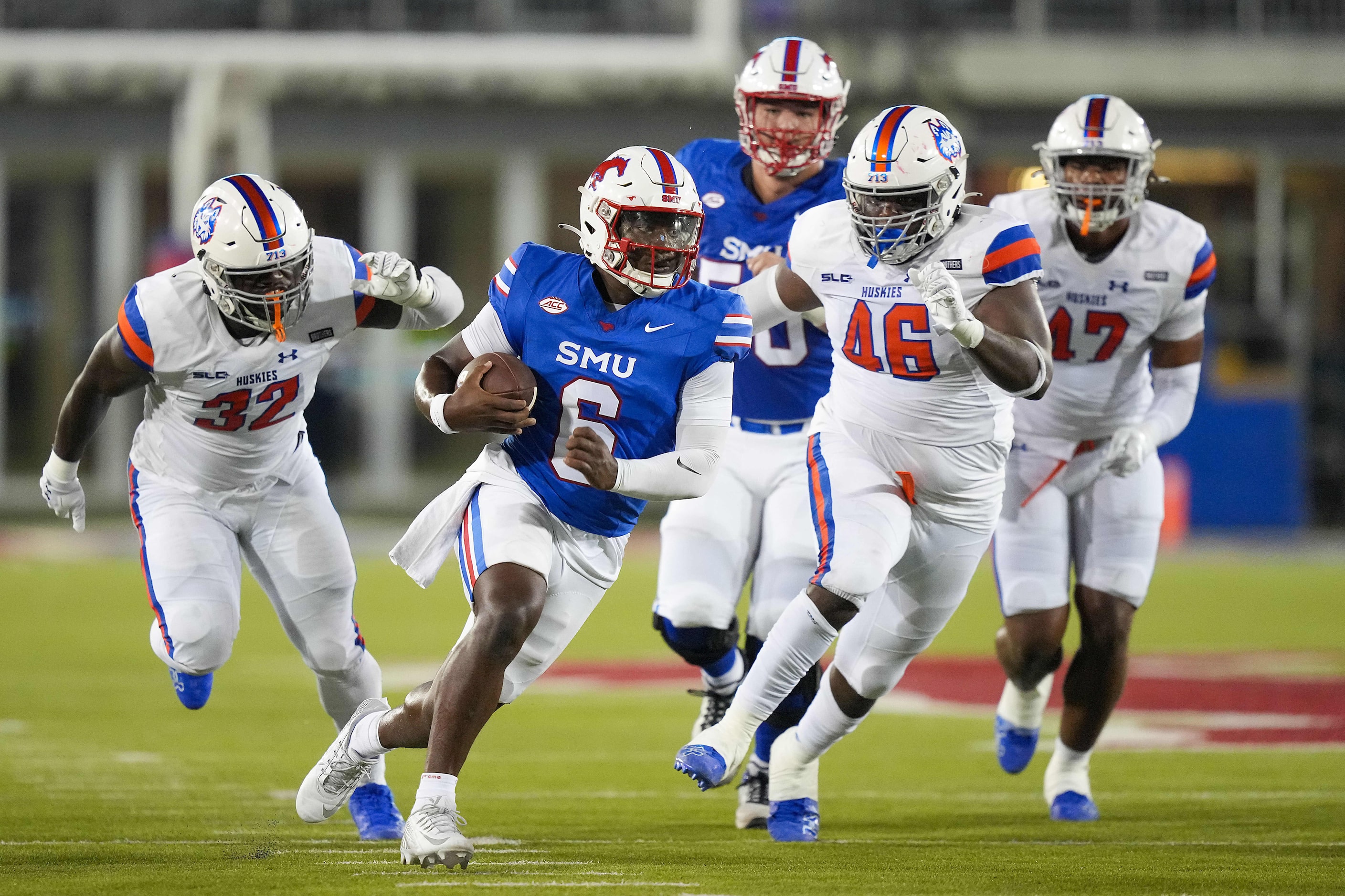 SMU quarterback Keldric Luster (6) runs past Houston Christian defensive tackle Julius Davis...