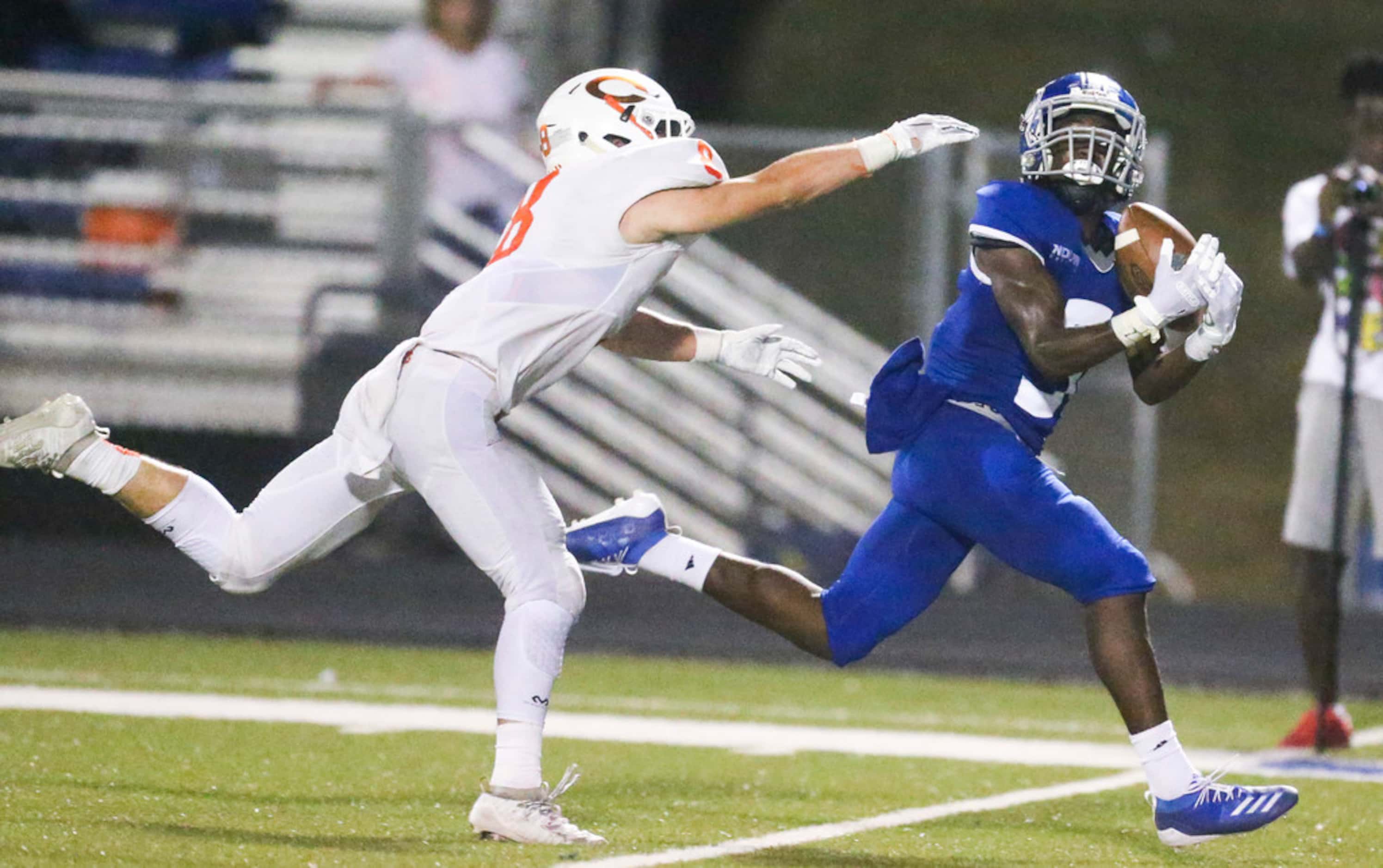 Nolan Catholic wide receiver Rodney Talton (9) hauls in a pass as he is defended by Celina...
