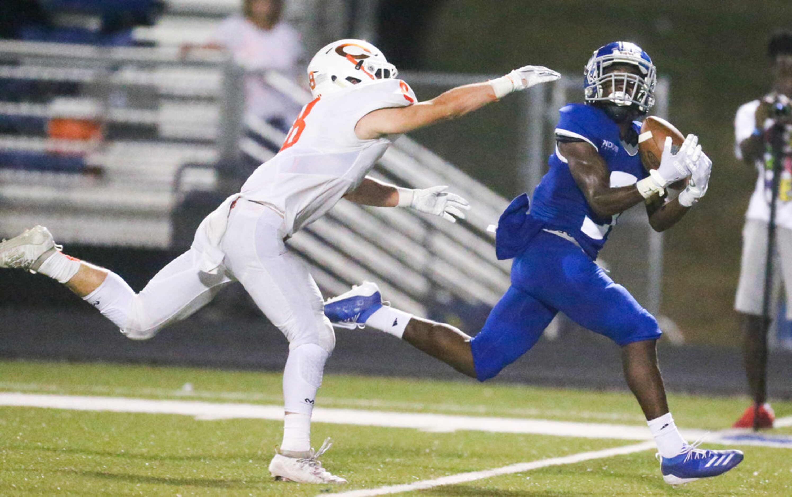 Nolan Catholic wide receiver Rodney Talton (9) hauls in a pass as he is defended by Celina...