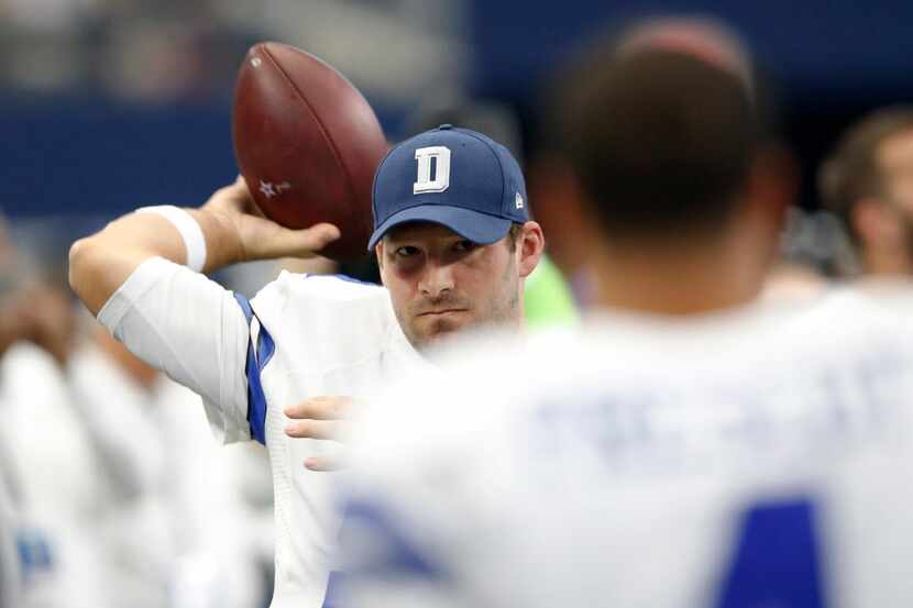 Dallas Cowboys quarterback Tony Romo (9) throws the ball towards Dallas Cowboys quarterback...