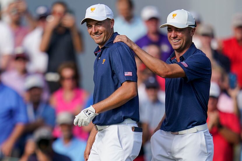 Jordan Spieth, left, and Justin Thomas celebrate winning the match on the 15th hole during...
