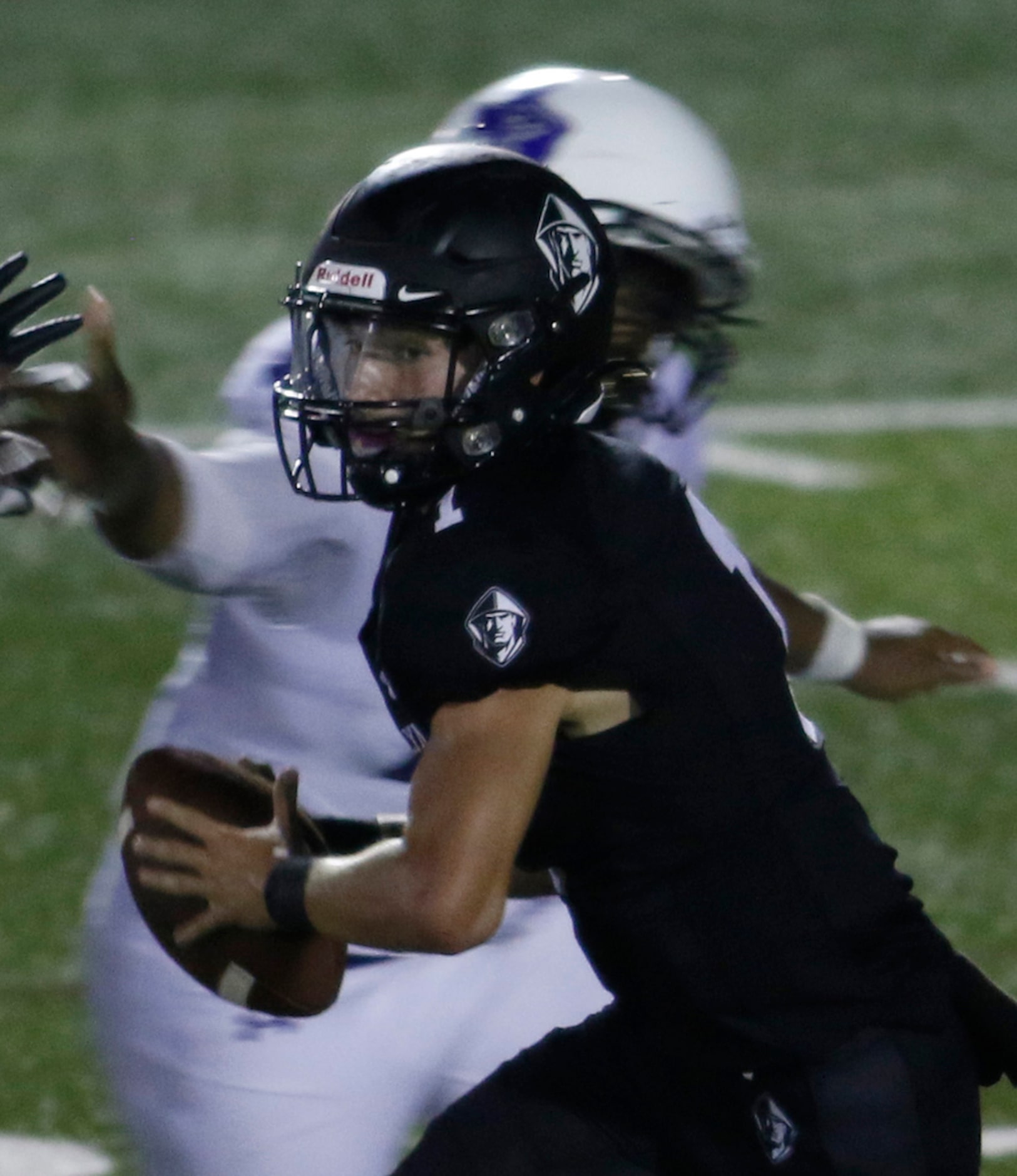 Bishop Lynch quarterback Michael Light (1) keeps his compose under pressure from the Trinity...