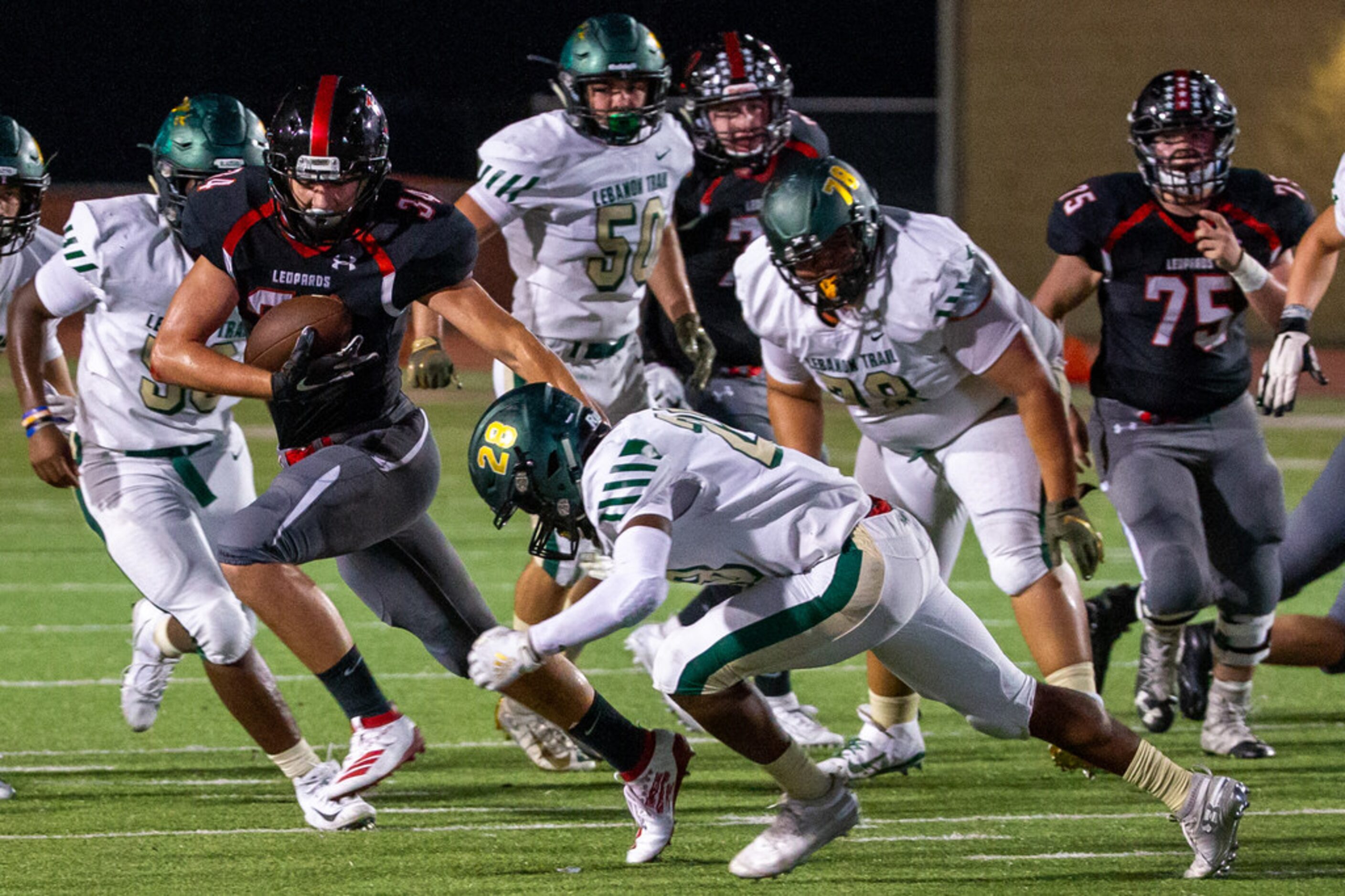 Lovejoy running back Koen Nunn keeps defense away during the football game between Lebanon...