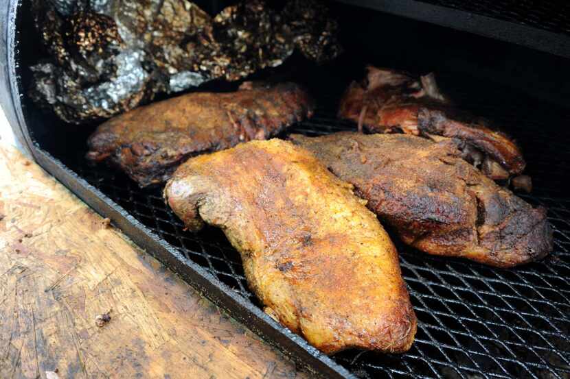 Brisket and ribs sizzle in the smoker at The Pink Pit at Taste of Dallas in Fair Park on...