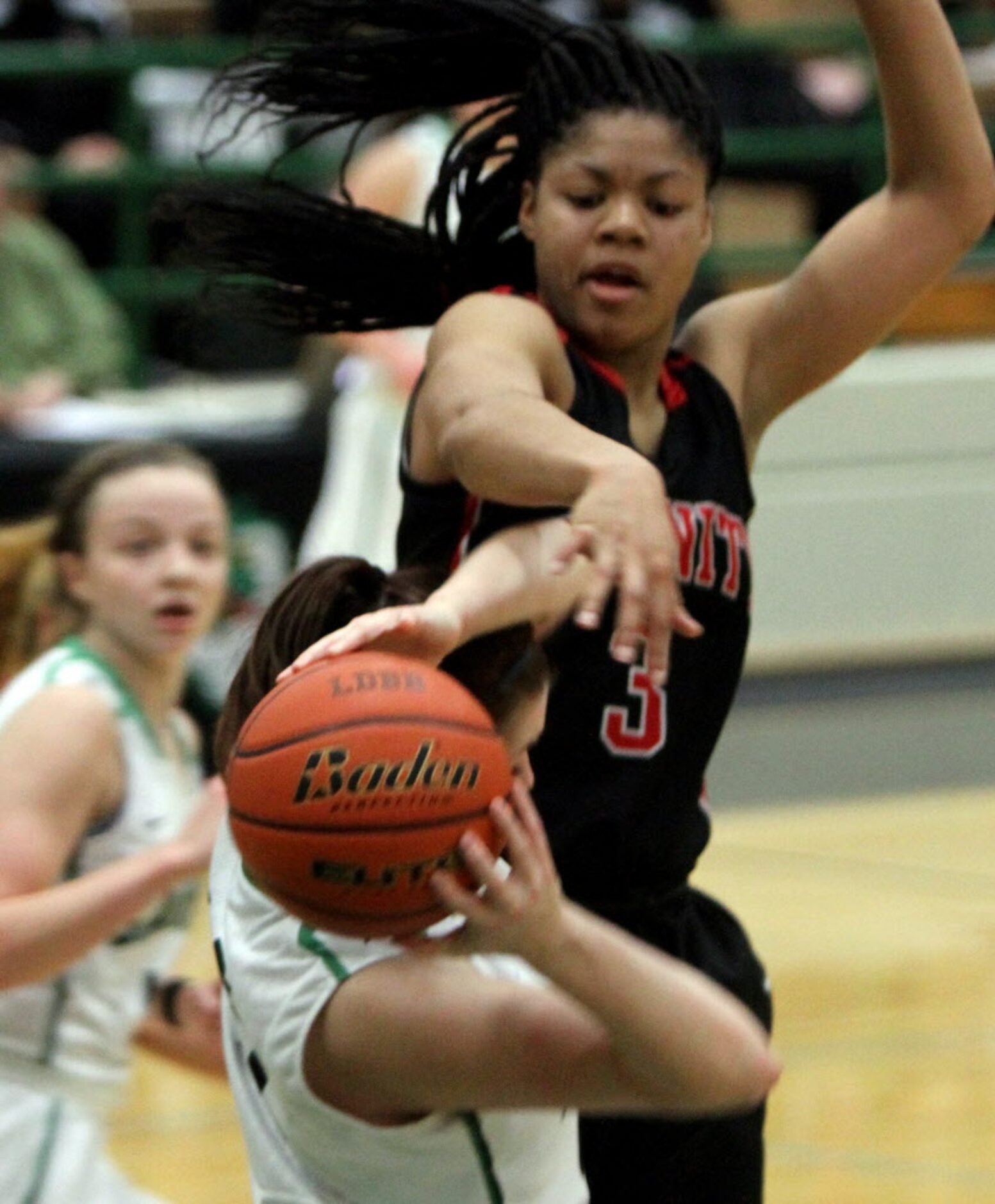 Euless Trinity guard Trinity Oliver (3) draws a foul as she defends Southlake Carroll post...