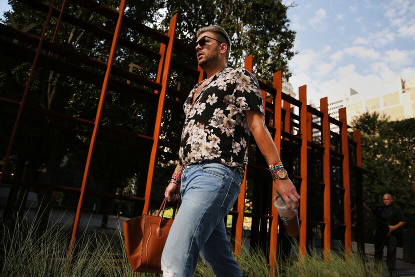 Reed Robertson of Dallas walks to work at Forty Five Ten along Elm Street. 