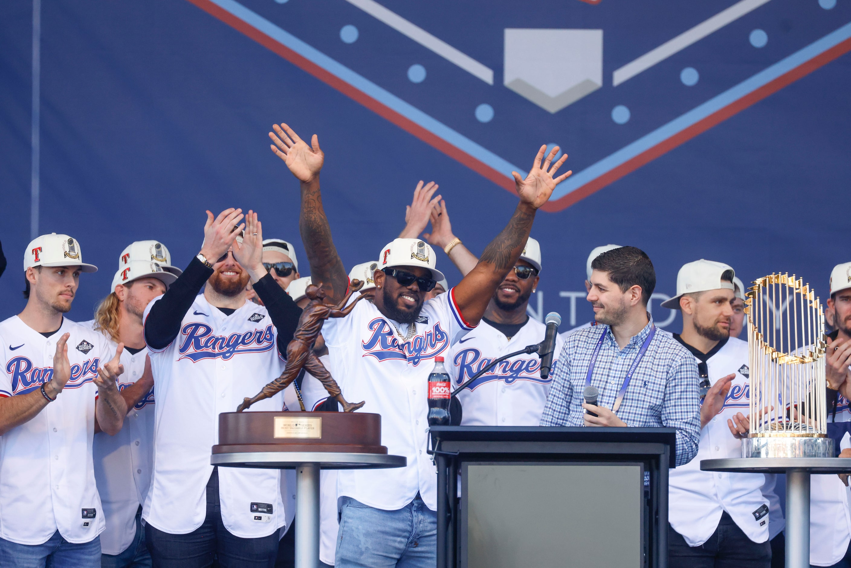 Texas Rangers’ Adolis García hoists the Commissioner's Trophy during Texas Rangers World...