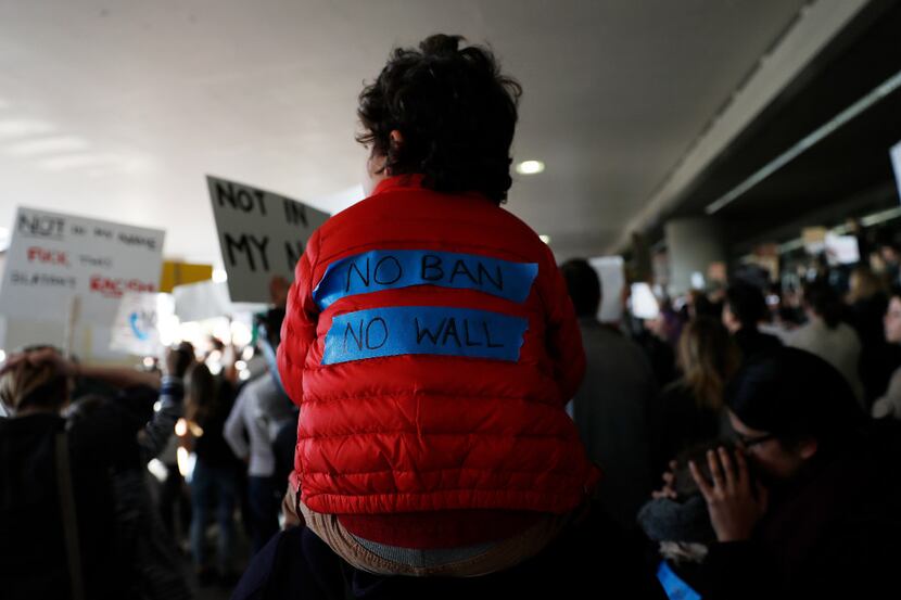 SAN FRANCISCO, CA - JANUARY 28: A child wears a slogan on his jacket during a rally against...