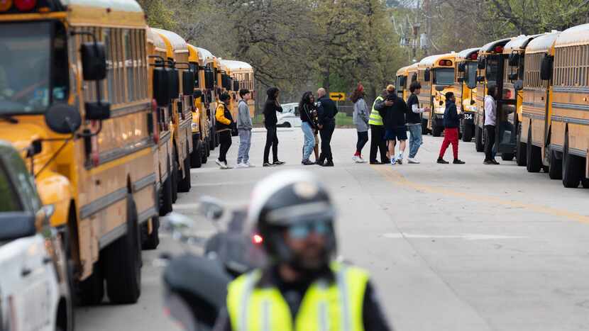 Arlington police officers blocked a street as Lamar High School students and faculty were...