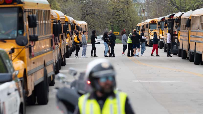 Arlington police officers blocked a street as Lamar High School students and faculty were...