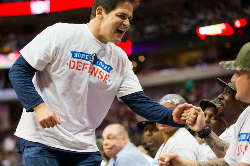 Mavs owner Mark Cuban greets eounded service members from Brooke Army Medical Center as the...