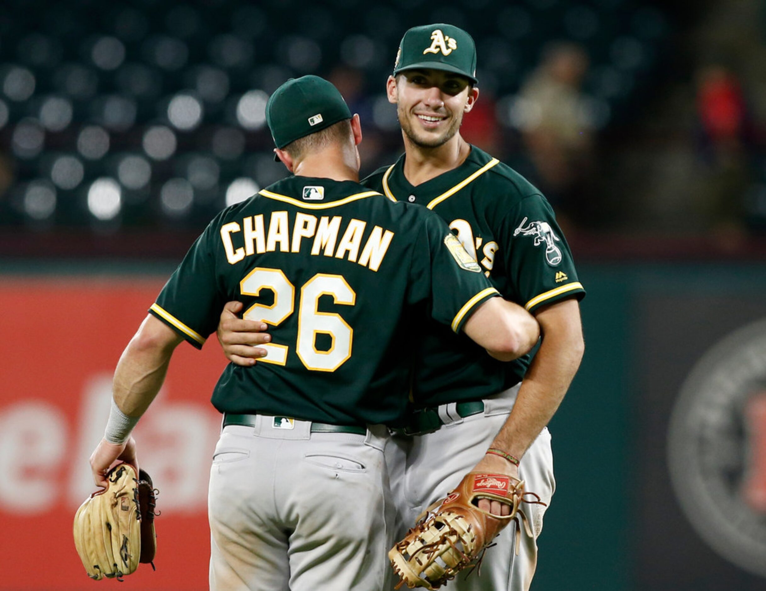 Oakland Athletics' Matt Chapman (26) and Matt Olson celebrate after beating the Texas...