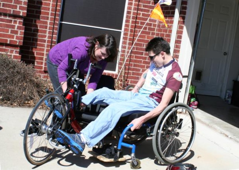 Lisa Dagley helps Alex Dagley, 27, onto his bike for some practice riding near their Frisco...