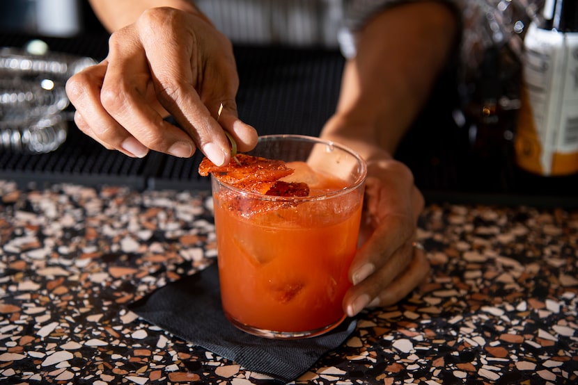 Bar Director Kimberly Schow places a chili mango garnish on “The Next Episode” cocktail at...