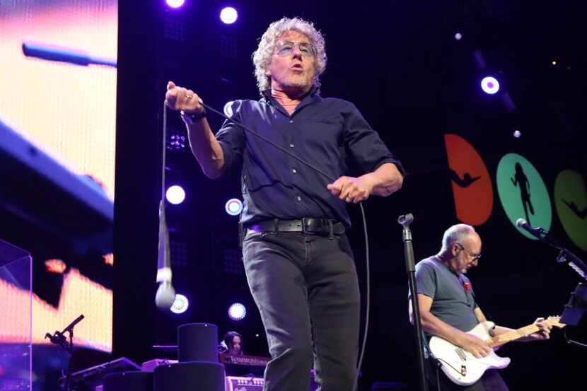 Roger Daltrey twirls his microphone during a Who concert at American Airlines Center on...