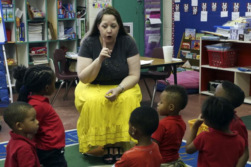 Sara Tinsley, a DISD certified teacher, works with her pre-k class at Good Street Learning...