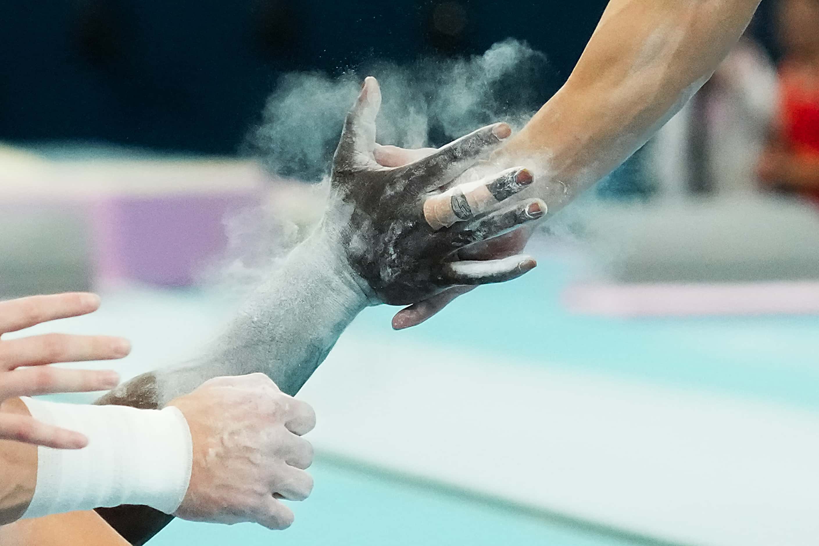 Asher Hong of the United States slaps hands with Frederick Richard after competing on the...