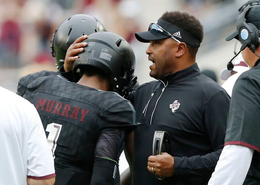 Texas A&M Aggies head coach Kevin Sumlin congratulates Texas A&M Aggies quarterback Kyler...