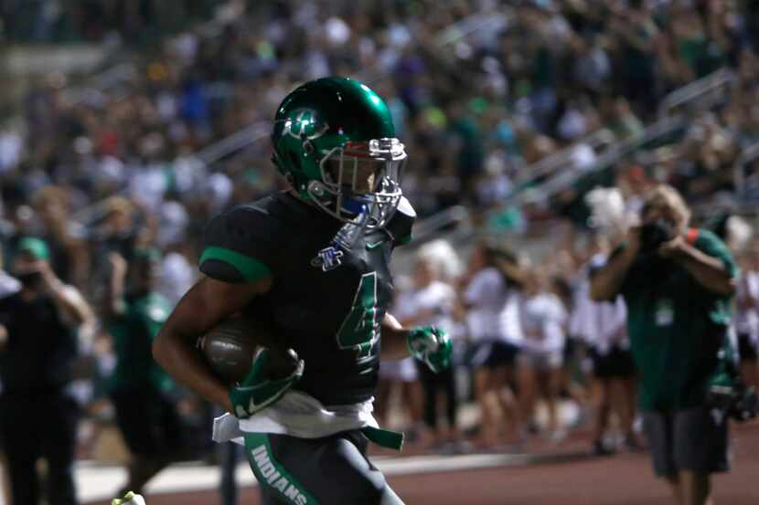 Waxahachie running back Jerreth Sterns (4) scampers into the end zone for a touchdown...