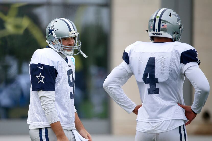 Dallas Cowboys quarterback Tony Romo (left) looks at Dak Prescott during practice at Ford...