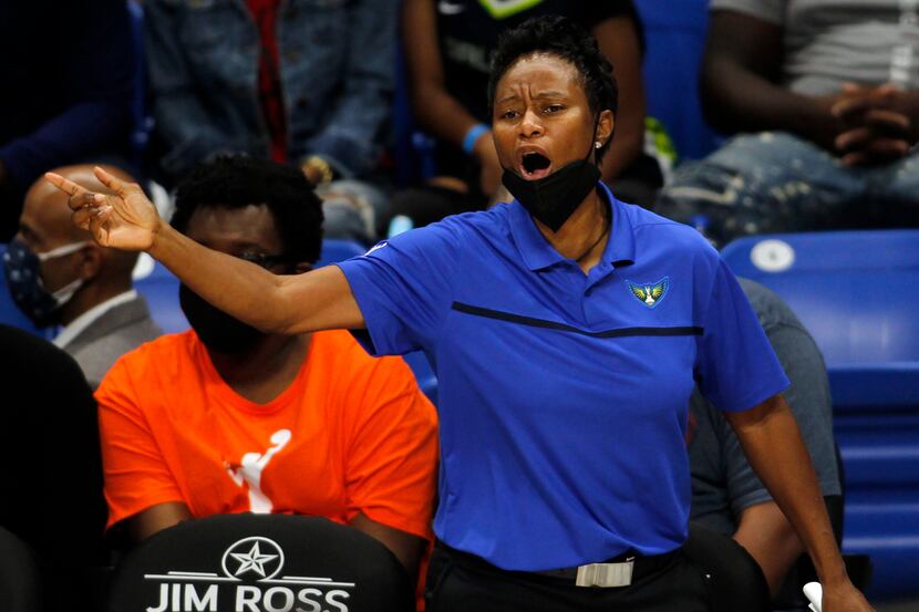 Dallas Wings head coach Vickie Johnson communicates with her players during first half...